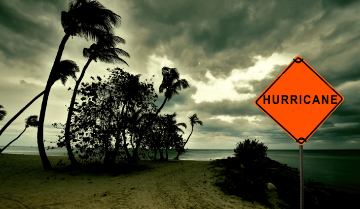 Beach with storm coming in and hurricane sign