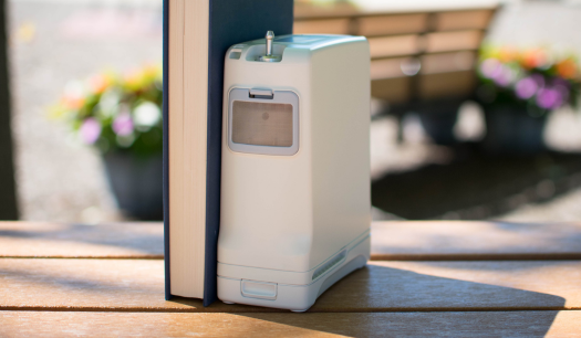 OxyGo Fit next to a book outside